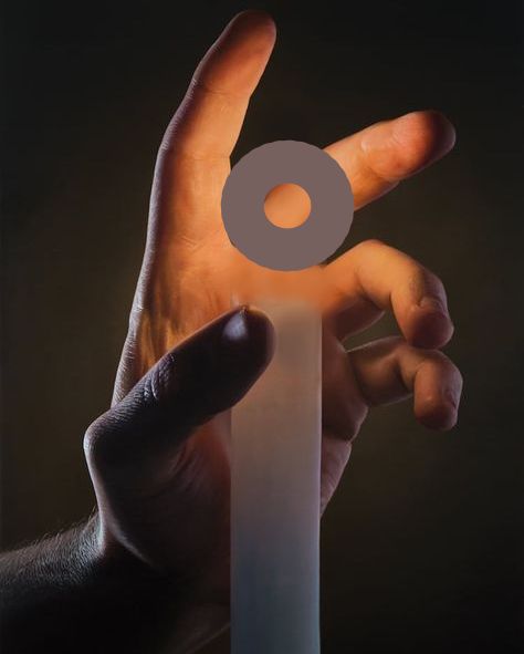 A hand grasping a glowing ring.